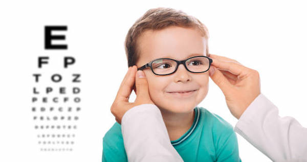 Child in green t-shirt pictured receiving glasses